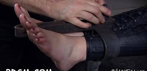  Bounded playgirl receives a painful and pricky feet worshipping